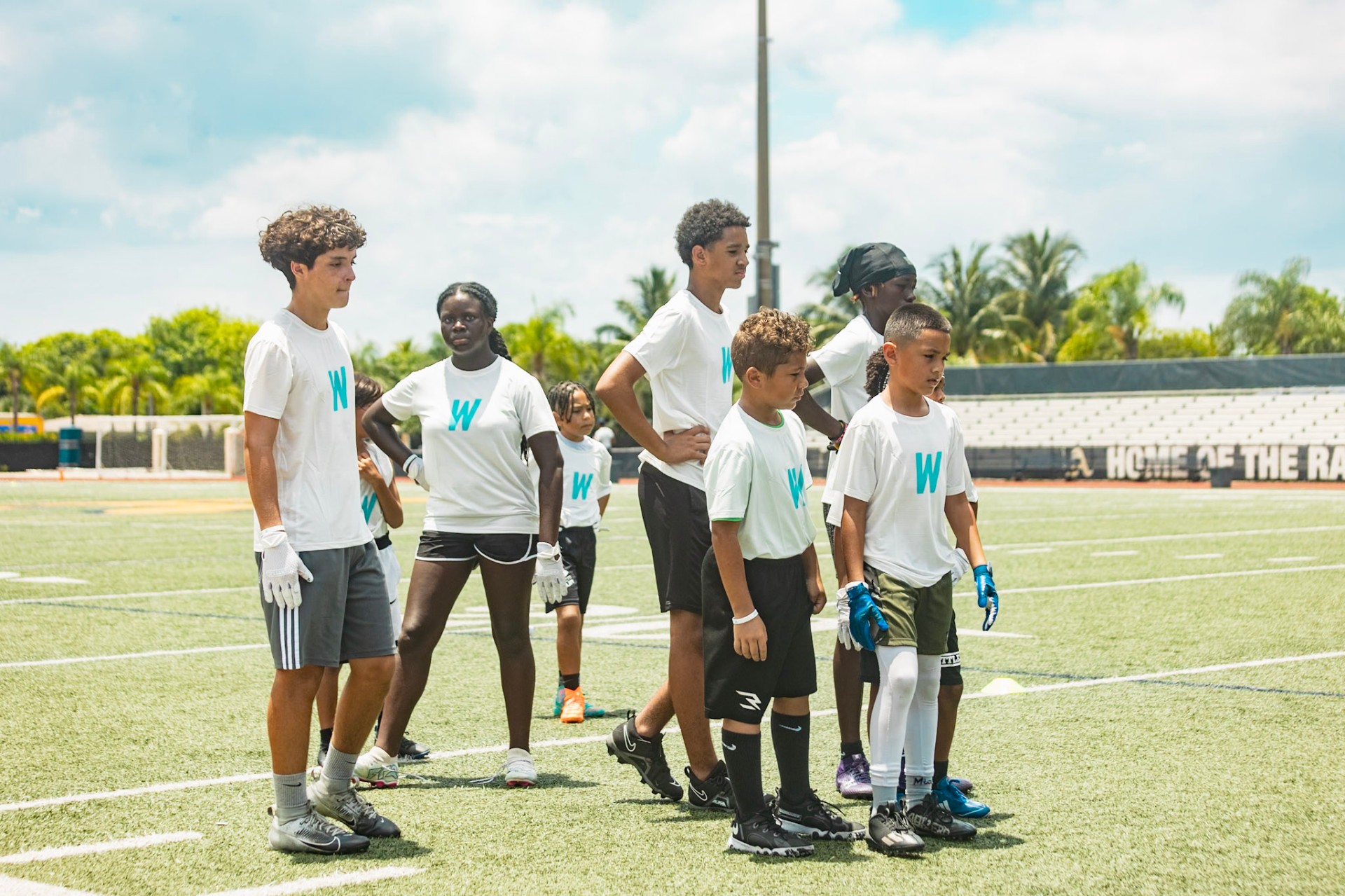 Young athletes in WeTrain gear lined up on the field at the Academy camp